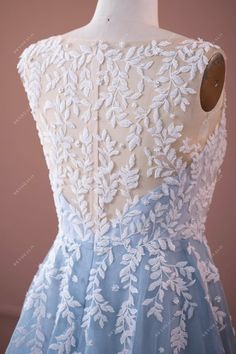 the back of a dress with white flowers on it, and blue tulle skirt