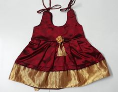 Baby girl grand silk frock golden border gives a grand look. This dress is idle for your angel's naming/cradle ceremony Your little one will look gorgeous in this if she wears it for wedding or for any other social occasion/function. Refer size chart ( skirt length ) and select the appropriate size required Product colour may slightly vary due to photographic lighting sources or your device settings. This has cotton inner lining which makes it comfortable even if she wears it for the whole day. Gold Festive Dress For Festivals, Gold Raw Silk Dress With Pallu, Gold Gown With Dori Work For Festive Occasions, Gold Festive Gown With Dori Work, Gold Self Design Dress For Diwali, Gold Self-design Dress For Diwali, Festive Gold Dress For Diwali, Gold Dress With Zari Work For Celebration, Traditional Gold Dress In Art Silk