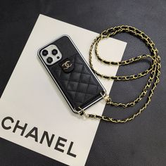 Lambskin Chanel Design: Crafted from luxurious lambskin leather adorned with the iconic Chanel button, this iPhone case exudes elegance and sophistication, showcasing the timeless allure of Chanel craftsmanship. Functional Card Holder: With a built-in card holder, this case offers convenience and practicality, allowing you to carry your essential cards securely alongside your iPhone. Crossbody Versatility: Featuring a crossbody strap, this case offers hands-free carrying options, providing bo... Luxury Gold Rectangular Phone Accessories, Elegant Rectangular Phone Accessories With Card Slots, Elegant Leather Rectangular Phone Accessories, Luxury Rectangular Mobile Phone Bag, Luxury Leather Phone Bag With Card Slots, Elegant Black Mobile Phone Bag Accessories, Elegant Black Phone Case, Elegant Black Rectangular Phone Case, Gold Rectangular Phone Case