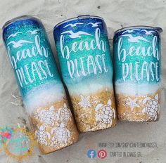 three beach themed tumbles sitting in the sand