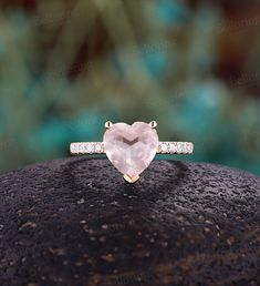 ----------------------Specifications---------------------- Center Stone - 9mm Rose Quartz Shape - Heart cut Side stones - Diamond or Moissanite  Shape -1.7mm Round cut Carat - about 0.2ct Diamond Color - G-H; Clarity - SI-VS Moissanite Color - DEF; Clarity - VVS-VS ----------------------DIMENSIONS---------------------- Ring head size - 10.0*9.0 mm The Width of the Band - 1.9 mm The Thickness of the Band - 1.3 mm Ring head - 6.0 mm in height Weight of gold - about 3.5g  -------------------------- Rose Gold Heart Cut Jewelry For Proposal, Heart-shaped Rose Gold Ring With Gemstone, Valentine's Day Heart-shaped Crystal Promise Ring, Pink Gemstone Heart Ring For Wedding, Heart-shaped Crystal Ring For Gifts, Rose Quartz Heart Ring, Rose Quartz Ring Engagement, Quartz Engagement Ring, Rose Quartz Ring