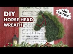 a horse head wreath hanging on the side of a wall next to a christmas tree