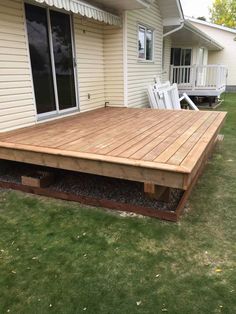 a wooden deck in front of a house