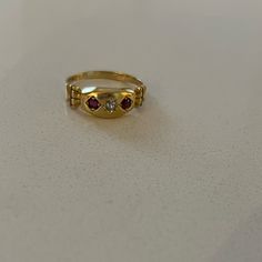 Antique 18k Garnet Diamond Gypsy Ring From Birmingham C 1901. This Yellow Gold Edwardian Ring Features Two Round Cut Garnets And One European Cut Diamond In A Marquis Setting. The Shoulders Of This Antique Ring Have A Columnar Architecture To Them. Ring Is Sized To 6 3/4; There Is A 18k Stamp Inside. Heirloom Gold Ruby Ring With Diamonds, Heirloom Yellow Gold Ruby Signet Ring, Heirloom Ruby Signet Ring In Yellow Gold, Classic Yellow Gold Three Stone Ruby Ring, Classic Three Stone Ruby Ring In Yellow Gold, Classic Three Stone Yellow Gold Ruby Ring, Heirloom Gold Ruby Ring With Rose Cut Diamonds, Three Stone Ruby Ring In 14k Yellow Gold, Heirloom Ruby Ring With Rose Cut Diamonds In Gold