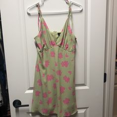 Women’s Medium Vici Mini Dress. New W/Tag. Light Green With Bright Pink Floral. V-Neckline. Adjustable Tie Straps. Flowy Bottom. Lined With Green Fabric, Not See-Through. Zipper Closure In Back With Clasp. True To Size. Smoke Free Home. Perfect Summer Dress! Trendy Green Sundress For Spring, Green V-neck Sundress Mini Dress, Green V-neck Sundress, Green V-neck Sundress For Brunch, Green V-neck Sundress For Day Out, Feminine V-neck Lined Sundress, Casual Pink V-neck Sundress, Pink V-neck Lined Sundress, Pink Fitted V-neck Sundress