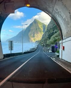 an empty road with mountains in the background