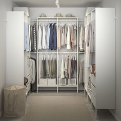 a white closet filled with lots of clothes