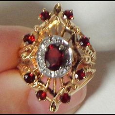 Vintage Victorian Filigree Garnet And Diamond Ring! Authentic Antique! This Is A Gorgeous, Vintage, 14k Solid Yellow Gold Filigree, Art Nouveau Design Ring, Is In A Marquise Shape, With A 4mm X 6mm Oval Cut Garnet In The Center, With A Diamond Halo. There Are Also Eight 2mm Round Cut Garnets In The Filigree, Marquise Shape Design. The Total Weight Of This Stunning Size 6 1/4 Ring Is 6.3 Grams. The Face Measures 25mm North To South. And The Ring Is Not Resizable. The Eight Diamonds Are Genuine, With A Total Carat Weight Of Approx. 0.04, H-I Color, And Si-I Clarity, All Prong Set. The Genuine Garnets, 9 In Total, Have A Carat Weight Of 0.90. In Pristine Condition, This Antique Piec Oval Filigree Ring With 17 Jewels For Anniversary, Ornate Yellow Gold Filigree Ring With Gemstone, Ornate 14k Gold Ruby Ring For Anniversary, Gold Filigree Ruby Ring Fine Jewelry, Ornate Yellow Gold Ruby Ring Gift, Yellow Gold Ruby Ring With Filigree For Anniversary, Gold Ruby Ring With Filigree Fine Jewelry, Gold Ruby Ring With Filigree In Fine Jewelry Style, Gold Filigree Ruby Ring For Anniversary