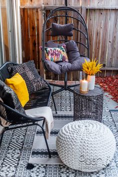 a patio with chairs and pillows on it