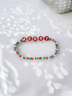 Get into the holiday spirit with this festive beaded bracelet! The colorful glass and plastic beads are strung on a durable elastic band that fits comfortably on any wrist without the need for a clasp. The 6-inch length makes it perfect for stacking with other bracelets or wearing alone as a statement piece. Celebrate Christmas in style with this handmade bracelet, featuring no stones but plenty of charm. The round shape and stackable design make it a versatile addition to any jewelry collection Adjustable Colorful Beaded Bracelets For Christmas, Holiday Multicolor Beaded Bracelets With Round Beads, Adjustable Beaded Christmas Bracelets, Holiday Green Beaded Bracelets, Green Beaded Bracelets For Holiday, Adjustable Christmas Beaded Bracelets, Green Beaded Bracelet For Holiday, Multicolor Beaded Bracelets With Round Beads For Holiday, Multicolor Beaded Bracelets For Holiday