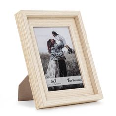 a wooden frame with an image of two people in the middle and one holding a dog