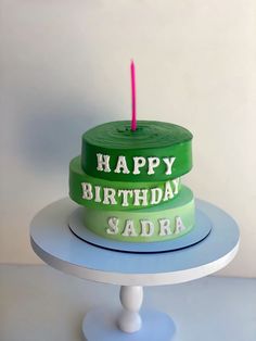 a birthday cake with the words happy birthday sadra on it and a candle in the middle