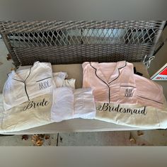 three shirts that say bride and groom on them sitting next to each other in front of a basket