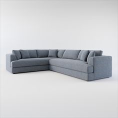 a gray sectional couch with pillows on it's back end and the seat facing outward