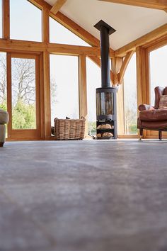 Open log burner sits on grey stone tile floor in oak beam house Grey Stone Tiles, Beam House, Stone Tile Flooring, Farmhouse Kitchens