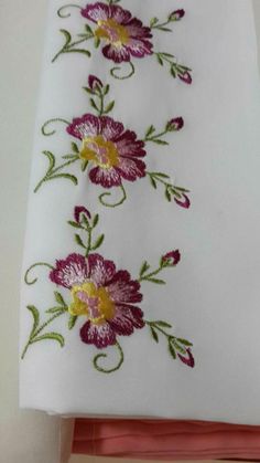 two white sheets with pink and yellow flowers on them