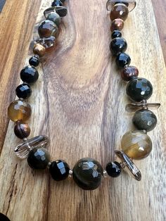 Stunning but understated, this design incorporates the earth tones of pearl, onyx, smoky quartz, deep green tiger eye, and jasper, with a large pewter shade lock. Green Tiger Eye, Floral Park, Stone Statement Necklace, Rock Chic, Deep Green, Smoky Quartz, Earth Tones, Tiger Eye, The Earth