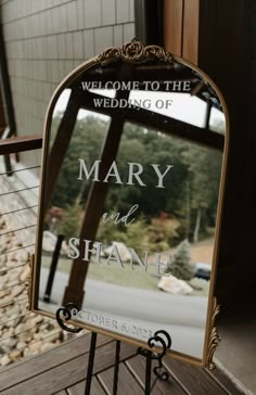 a mirror with the words mary and shanle written on it sitting on a stand