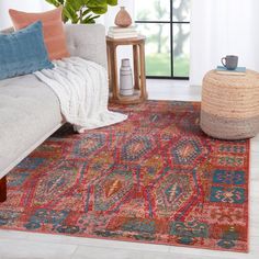 a living room area with a couch, coffee table and rug