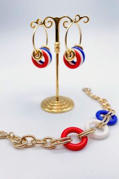 This Red, White, & Blue Gold Bracelet is the perfect accessory for adding some patriotic bling to your wardrobe! The chain alternates with circular rings with classic red, white, and blue tones, showing off a little bit of America's spirit in style. So throw it on and show your patriotic pride! Details:- Red, White, and Blue Colored Wings- Adjustable- Perfect 4th of July AccessoryDimensions:- 8.5" Resting Diameter- 1.25" Extension Trendy Red Circular Jewelry, Red Patriotic Jewelry For Party, Patriotic Red Jewelry For Party, Adjustable Blue Jewelry For 4th Of July, Red Jewelry For 4th Of July Party, Red Jewelry For Party On 4th Of July, Blue Jewelry For 4th Of July Party, Patriotic Blue Jewelry For Party, Red Patriotic Bracelet Jewelry