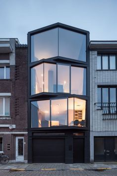 a tall building with lots of windows on it's side in front of some buildings