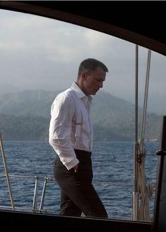 a man is walking on the deck of a boat