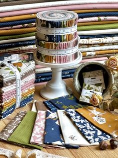 a table topped with lots of different types of fabrics