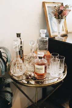 a table topped with lots of glasses and bottles