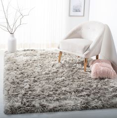 a white chair sitting on top of a shaggy rug