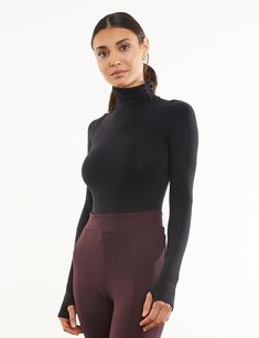 Made from a matte-black, seamless microfiber fabric with endless stretch, our sleek Ballet Turtleneck Bodysuit features thumbhole details and is finished with a raw-cut thong bottom. Pair under a sleeveless dress or with a wide-legged pant for a look as functional as it is fashionable. Product Details Luxury microfiber blend (87% nylon, 12% elastane, 1% cotton) Fit-tested by real women Seamless construction High stretch and recovery One size fits most Superior body contouring Snap gusset closure Turtleneck Bodysuit, Black Seamless, Jennifer Fisher, Fancy Pants, Long Sleeve Turtleneck, Body Contouring, Faux Leather Leggings, Leather Leggings, Real Women