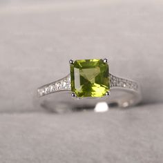 ◆ Hand-finished in Sterling sliver, this piece features a Asscher shaped peridot. Clear zirconia stones decorate half of the ring shank. A piece of classic, it is suitable for engagement, party, daily occasion. ◆ Production Description: Main stone Type: Peridot Main Stone Shape: Asscher Main Stone Size: 7*7mm Side stone: CZ Metal: 925 Sterling silver - Other options available in the drop down menu ◆ Customization: √Free for Add Engraving √Other Metal Type Available √Other Gemstones & Shapes Elegant Peridot Solitaire Ring, Heirloom Peridot Ring For Gift, Green Peridot Rings With Brilliant Cut, Polished Peridot Ring, Peridot Rings, Silver Peridot Rings With Polished Finish, Black Spinel Ring, August Birthstone Ring, July Birthstone Ring