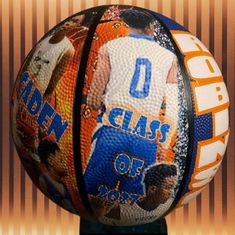 a close up of a basketball on a stand with an orange and blue background behind it