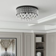 a chandelier hanging from the ceiling in a room with white walls and flooring