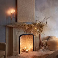 a fireplace with candles lit in front of it