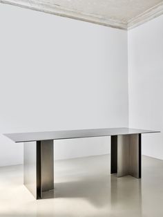 Metal is a minimalist table created by Moscow-based studio Rhyme. Crafted using precision metal-cutting technology, this table strikes a harmonious balance between elegance and durability. One of its standout features is the strict lines and well-proportioned design. With its elongated shape, it’s not only visually appealing but also practical for dining rooms and gatherings of various sizes. Metal Dining Table Modern, Metal Office Table, Metal Dining Table Base, Metallic Dining Table, Metallic Table, Black Metal Table, Architectural Dining Table, Brushed Metal Dining Table, Dining Table Design Minimalist