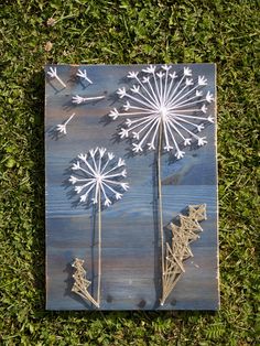 a piece of wood that has been painted with white paint and some flowers on it