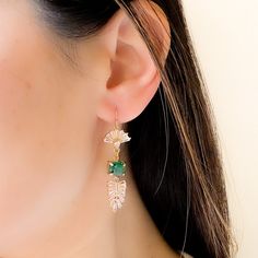 Our enchanting Green Dangle Earrings features rectangular emerald crystal and exquisite leaf dangles reminiscent of vintage deco aesthetics. Perfect for rustic weddings and outdoor ceremonies, these stunning nature inspired crystal earrings serve as exquisite bridal/ wedding accessories, adding a whimsical charm to your special day. Also available with clear crystals DETAILS : ------------ - 14K gold filled ear wires - glass crystal stones - emerald green crystals - gold plated setting DIMENSION Green Dangle Hoop Earrings For Wedding, Dangle Earrings With May Birthstone, May Birthstone Drop Earrings With Ear Wire, May Birthstone Crystal Drop Earrings, Single Dangle Earring For May Birthstone, Dainty Earrings For Wedding, May Birthstone, Dainty Earrings For Wedding With May Birthstone, Dainty Green Earrings For Wedding, May Birthstone Drop Earrings For Wedding