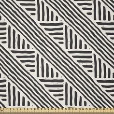 black and white striped fabric with diagonal stripes on the side, in front of a ruler