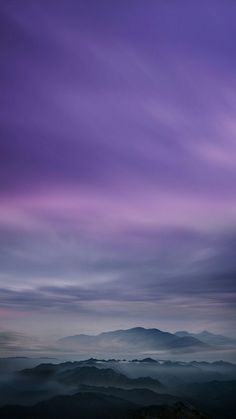 purple and blue sky with clouds over mountains