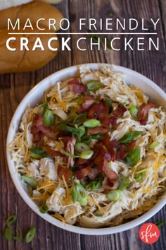 a white bowl filled with bacon, cheese and green onions on top of a wooden table