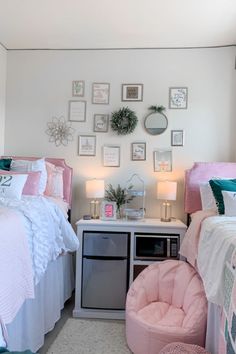 a bedroom with two beds, a chair and pictures on the wall