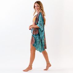 Indulge in comfort and luxury with the Lotus & Luna Canggu Kimono. Perfect for any occasion, this versatile kimono can be dressed up or down to elevate your style. Made with machine-washable 100% rayon, it's easy to care for and features a flattering fit for sizes S to 3X. Available in stunning orange and teal, you'll be sure to turn heads wherever you go. Printed Summer Outerwear For Beach, Printed Outerwear With Kimono Sleeves For Vacation, Bohemian Green Outerwear For The Beach, Casual Wrap Kimono In Rayon, Green Open Front Kimono For Beach Cover-up, Green Open Front Kimono For Beach, Summer Green Open Front Kimono, Green Open Front Summer Kimono, Green Summer Outerwear For Vacation