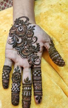 henna tattoo on the palm of a woman's hand