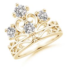 a yellow gold ring with two diamonds on top and an intricate design around the band