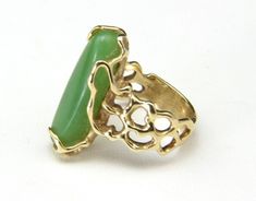 "Vintage 14k Jade Ring -Artisan, freeform modern design -Marked \"14k\" yellow gold -Beautiful bright green oblong jade stone -Ring is size 6 -Surface measures .9\" x .3\" -Depth of the ring measures .26\" -Band width .2\" -Weight 8.5g In very good vintage condition, band is beautiful with no apparent scratches, ready to wear!" Modern Oval Green Jewelry, Modern Green Cabochon Rings, Modern Green Cabochon Jewelry, Modern Green Chrysoprase Jewelry, Modernist Green Ring As A Gift, Modernist Green Ring For Gift, Green Modernist Ring As A Gift, Modernist Green Rings For Gift, Green Modernist Ring As Gift