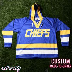 Charlestown Chiefs Slap Shot Custom Lace-Up Hockey Hoodie. Features:-Combines the fashion of a jersey with the performance of a hooded sweatshirt.-Constructed with our premium Vulcan Winterized fabric.-Inner polar fleece lining-Thick enough to keep you warm in cold temps, while being light and flexible enough to wear in supreme comfort.-Bottom adjustable drawcord-Lace-up collarColors:Royal, gold, white Free PersonalizationAdd your own name and number for free.*If you do not specify a custom name The Benchwarmers, Chiefs Hoodie, The Mighty Ducks, Slap Shot, Hockey Hoodie, Mighty Ducks, Custom Baseball Jersey, Custom Jerseys, Hockey Jersey