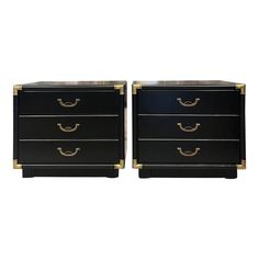 a pair of black and gold nightstands