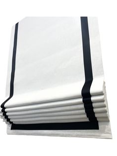 six white sheets with black trims on each side and one is folded in half