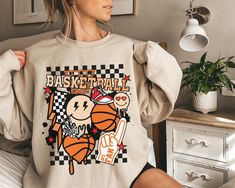 "Get ready to rock that casual chic look with our Basketball Sweatshirts For Women ❤️ Get retro with this retro basketball sweatshirt! This design is perfect for all cool basketball mom, basketball girl, basketball boy or just a basketball game lover out there. Show off your retro style and spread basketball season vibes with this basketball sweater. ❤️ Size up, babe! Go 1-2 sizes bigger for that oversized stunner. Elevate your style, own the spotlight, and unleash your fashion power. It's time Hand Printed Shirt, Jesus Christmas Shirt, Cool Basketball, Girl Basketball, Basketball Girl, Tennessee Shirt, Basketball Sweatshirts, Zodiac Shirts, Basketball Mom