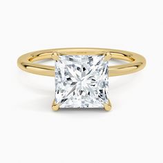 a princess cut diamond ring in yellow gold